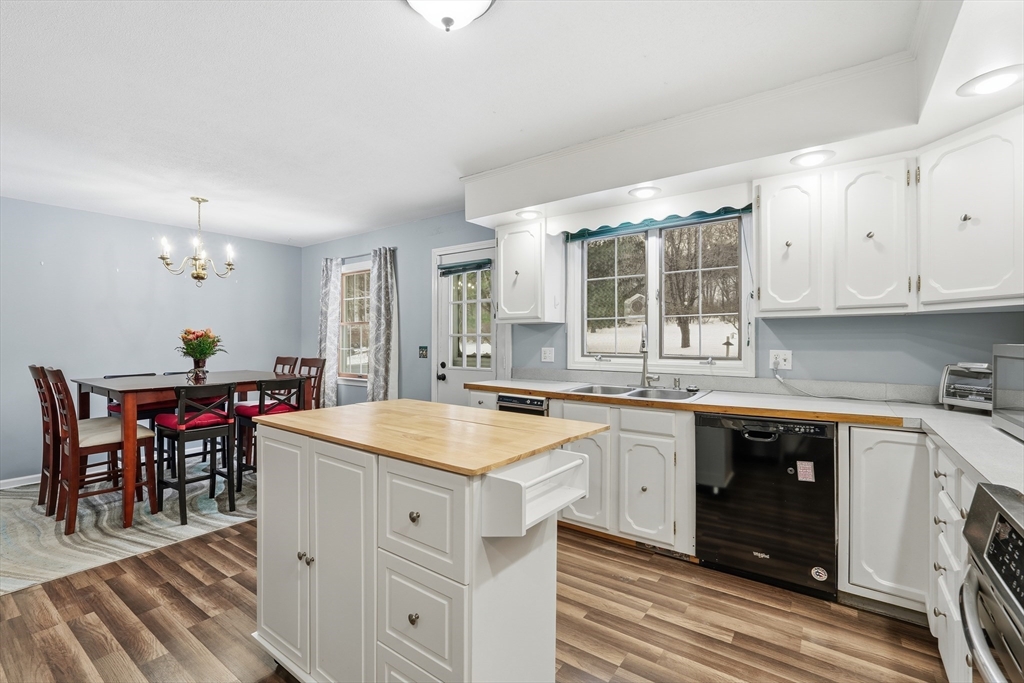 32 Homestead Avenue Greenfield, MA 01301 - Photo 13 of 41 a kitchen with a stove a sink a dining table and chairs
