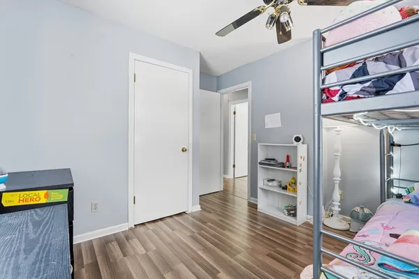 a view of a hallway view with wooden floor and closet
