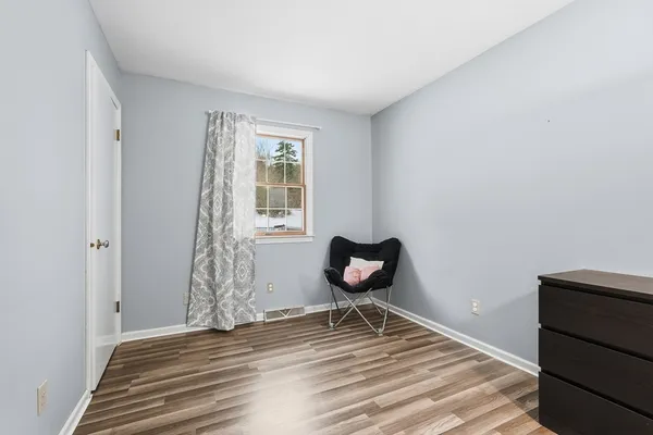a view of a livingroom with wooden floor and a window
