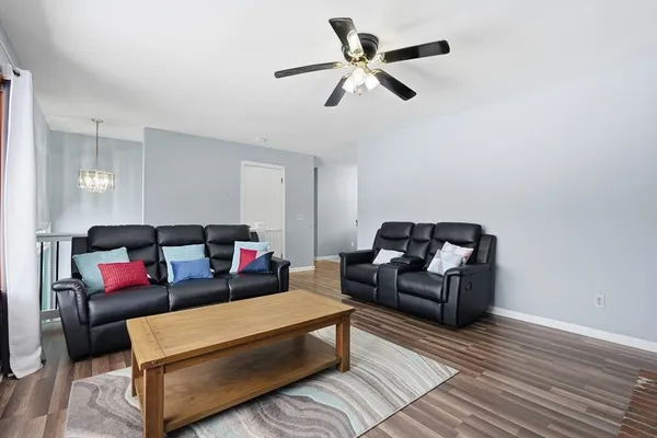a living room with furniture and a ceiling fan