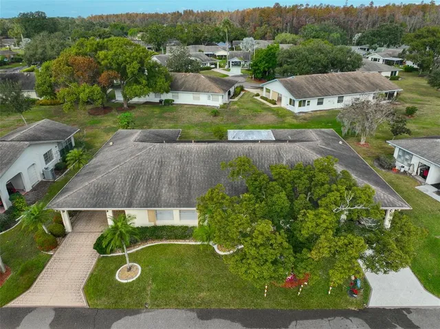an aerial view of residential houses with outdoor space and lake view