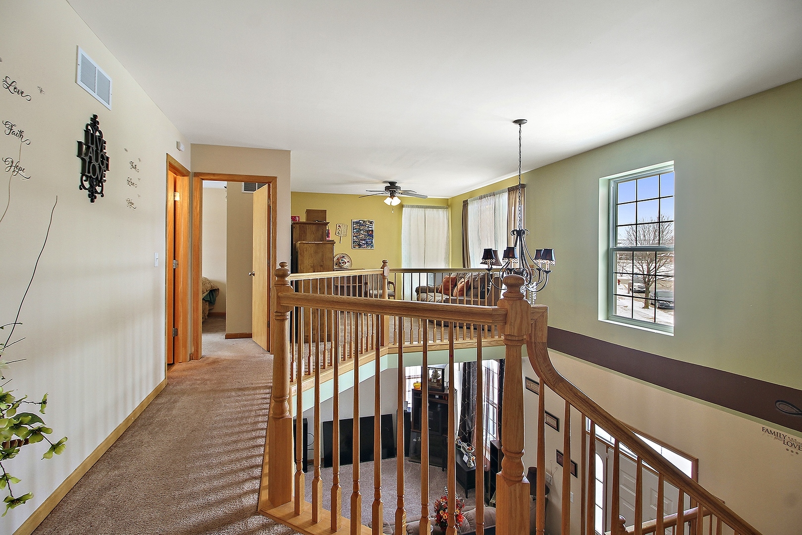 1906 Tallgrass Turn Kankakee, IL 60901 - Photo 12 of 23 a view of a hallway with windows and chandelier