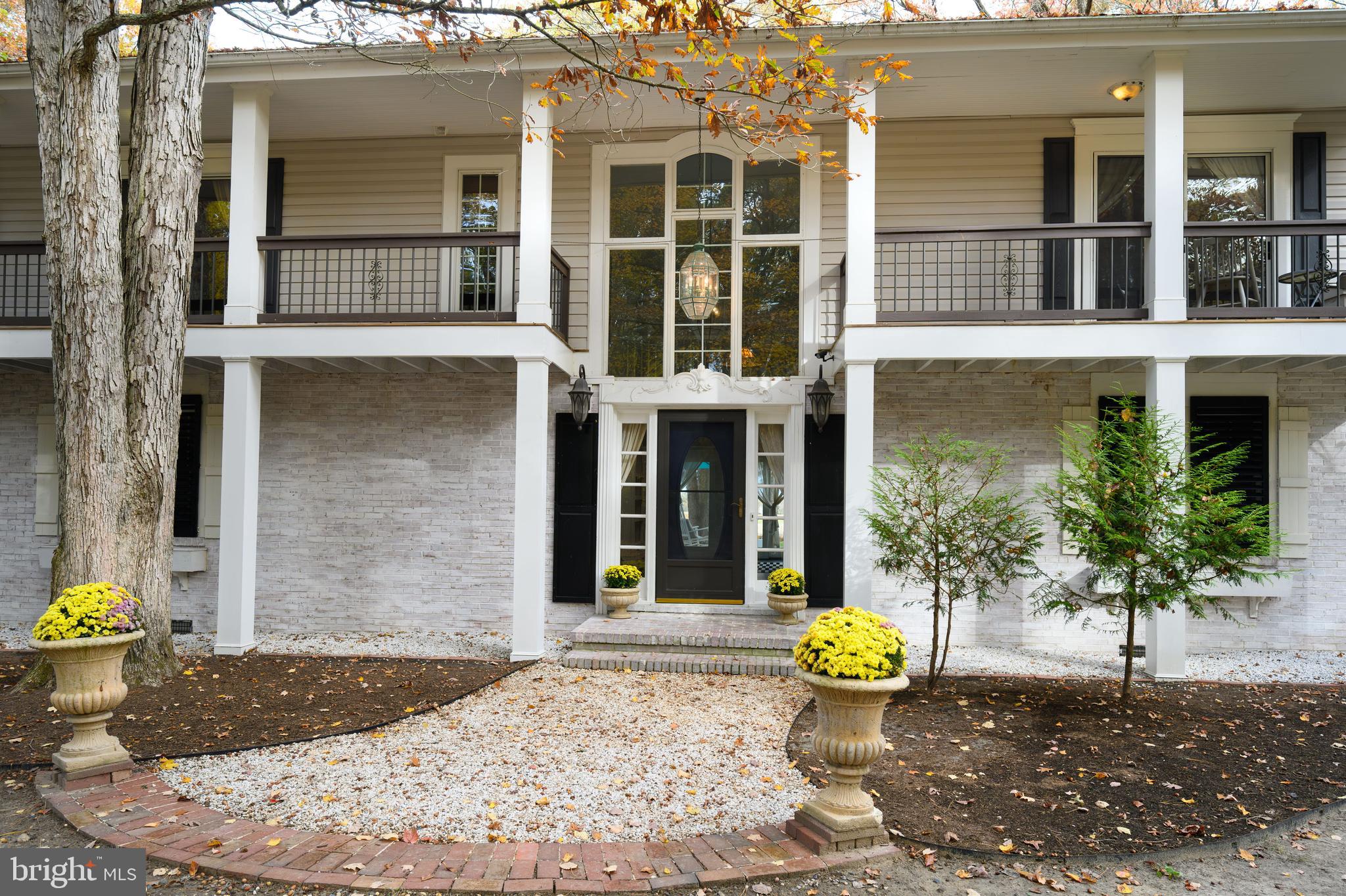 2669 Ocean Gateway Trappe, MD 21673 - Photo 12 of 47 a view of a brick house with potted plants