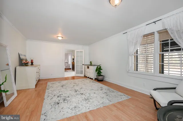 a living room with furniture and a dresser