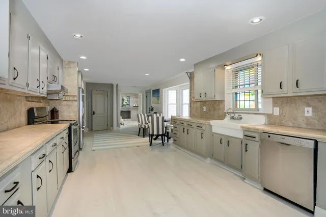 a kitchen with cabinets appliances and a window