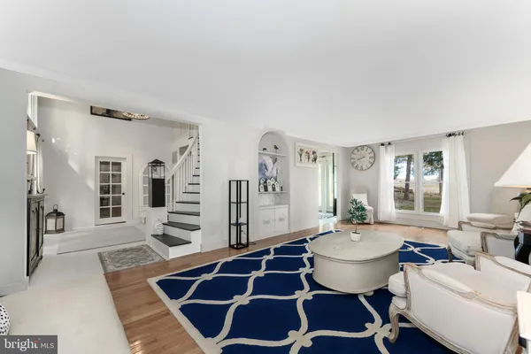 a living room with furniture a table and chair