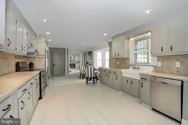 a kitchen with cabinets appliances and a window