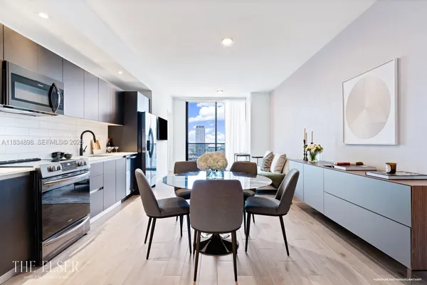 a view of a dining room with furniture and wooden floor