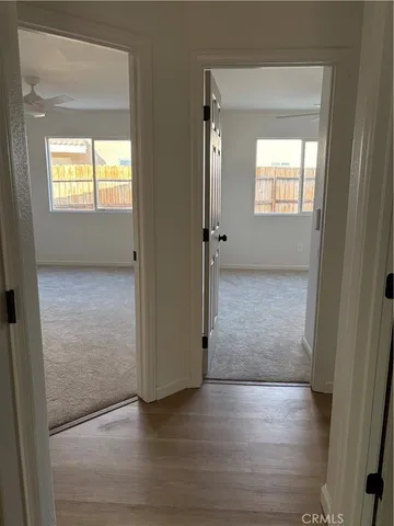 an empty room with windows and closet
