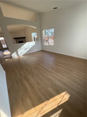a view of empty room and wooden floor