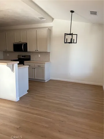 a kitchen with stainless steel appliances granite countertop a sink a stove and a refrigerator