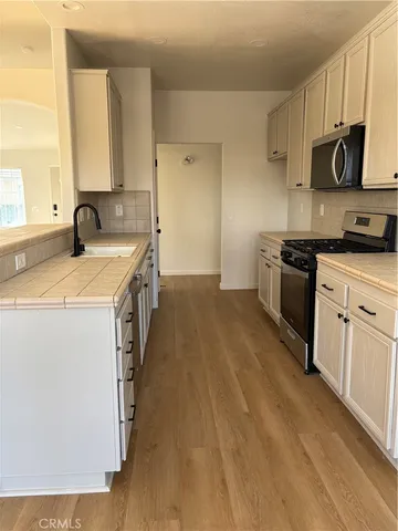 a kitchen with a sink stove and cabinets