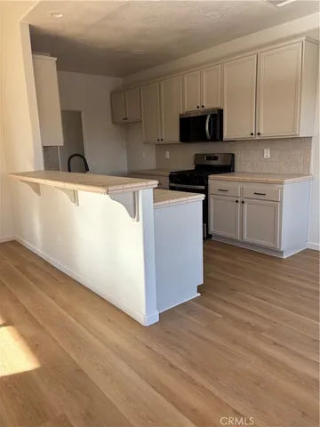 a kitchen with granite countertop a sink and a stove top oven