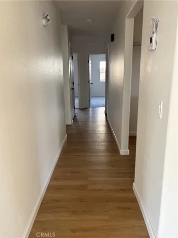 a view of a hallway with wooden floor