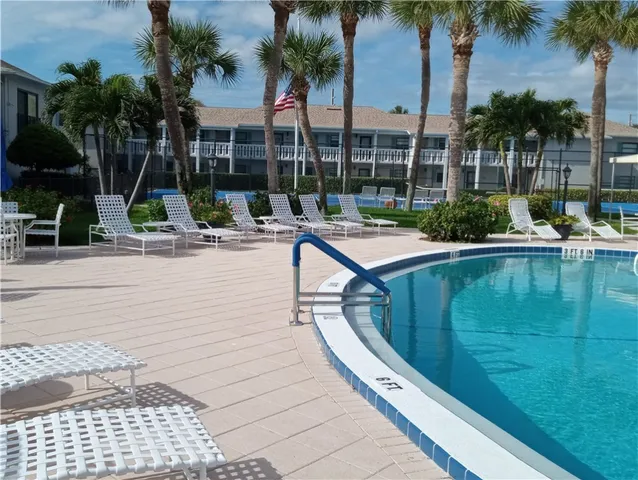 a view of swimming pool with outdoor seating