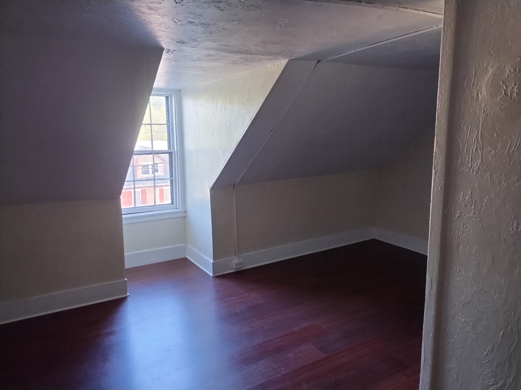 429 Main Street, Unit 429 Hardwick, MA 01031 - Photo 8 of 10 an empty room with wooden floor and windows