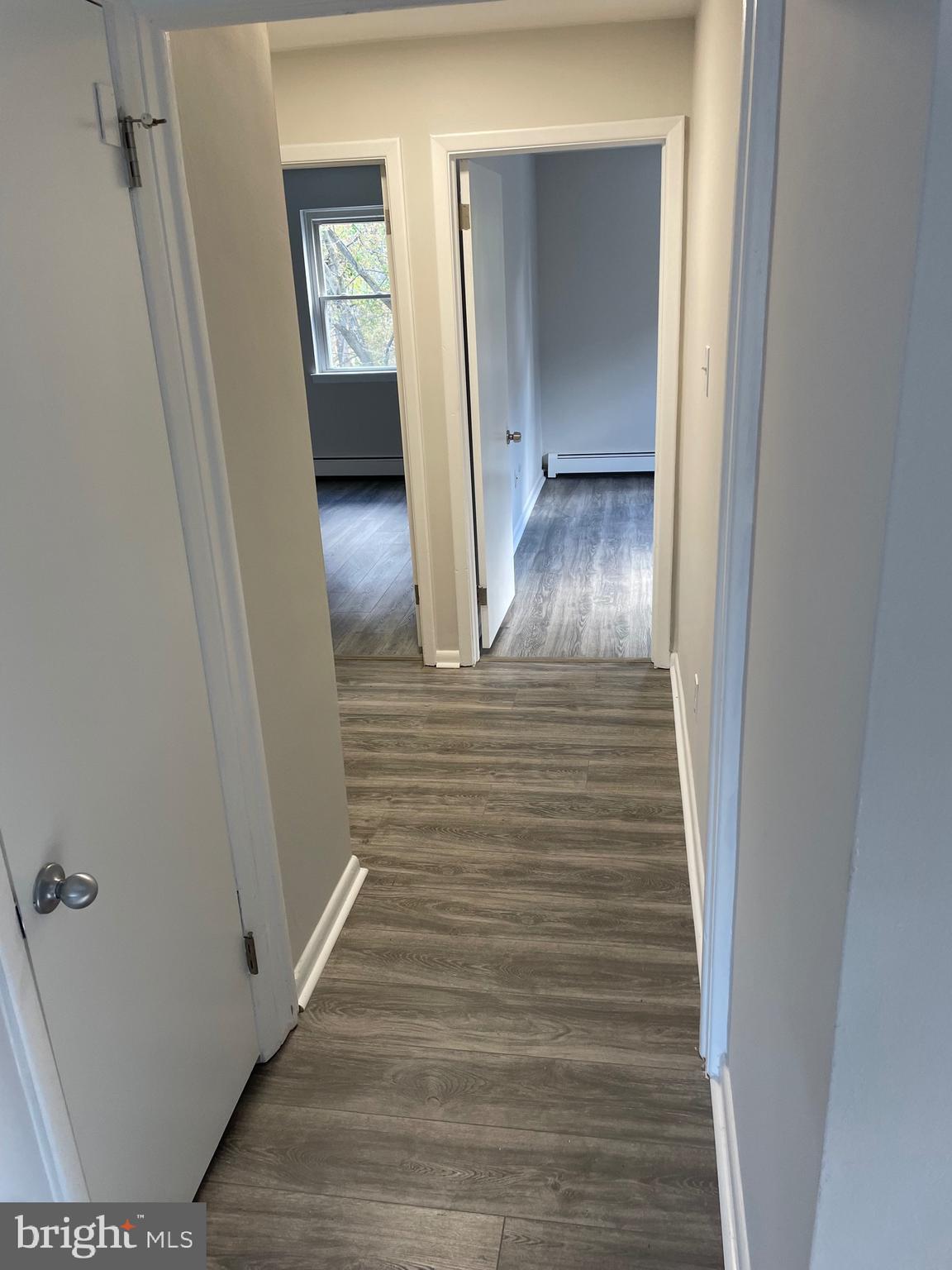 123 4th Avenue, Unit B Broomall, PA 19008 - Photo 4 of 7 a view of a hallway with wooden floor and staircase