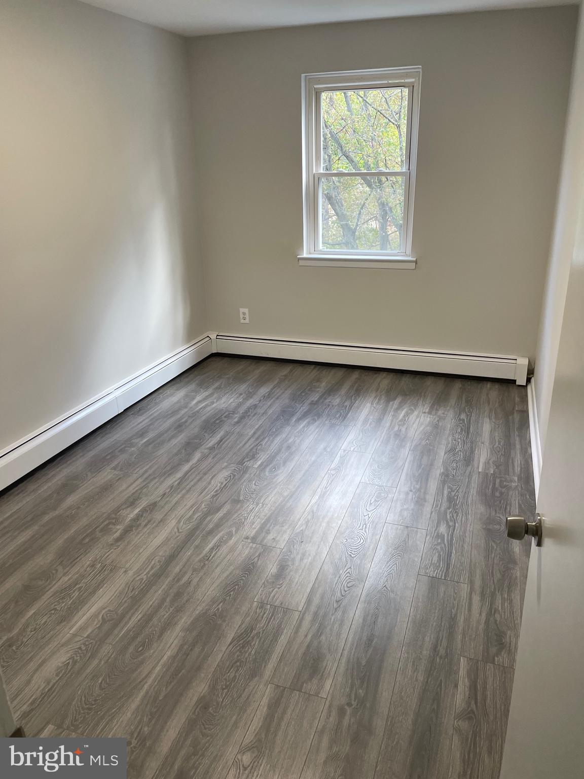 123 4th Avenue, Unit B Broomall, PA 19008 - Photo 6 of 7 an empty room with wooden floor and windows