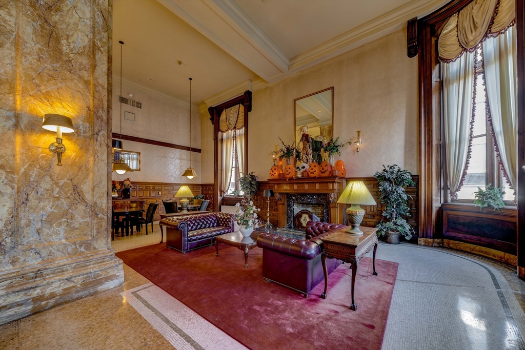 140 Chestnut Street, Unit 310 Springfield, MA 01103 - Photo 20 of 25 a living room with furniture a window and a fireplace