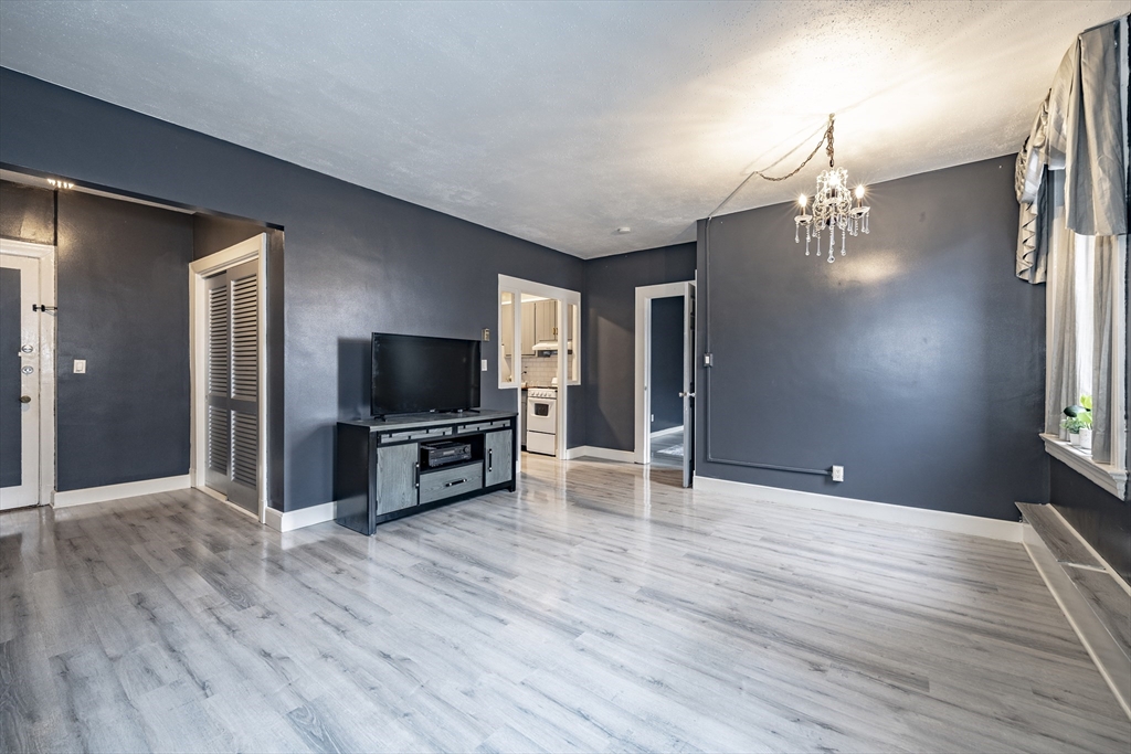 140 Chestnut Street, Unit 310 Springfield, MA 01103 - Photo 2 of 25 a view of livingroom with kitchen and furniture