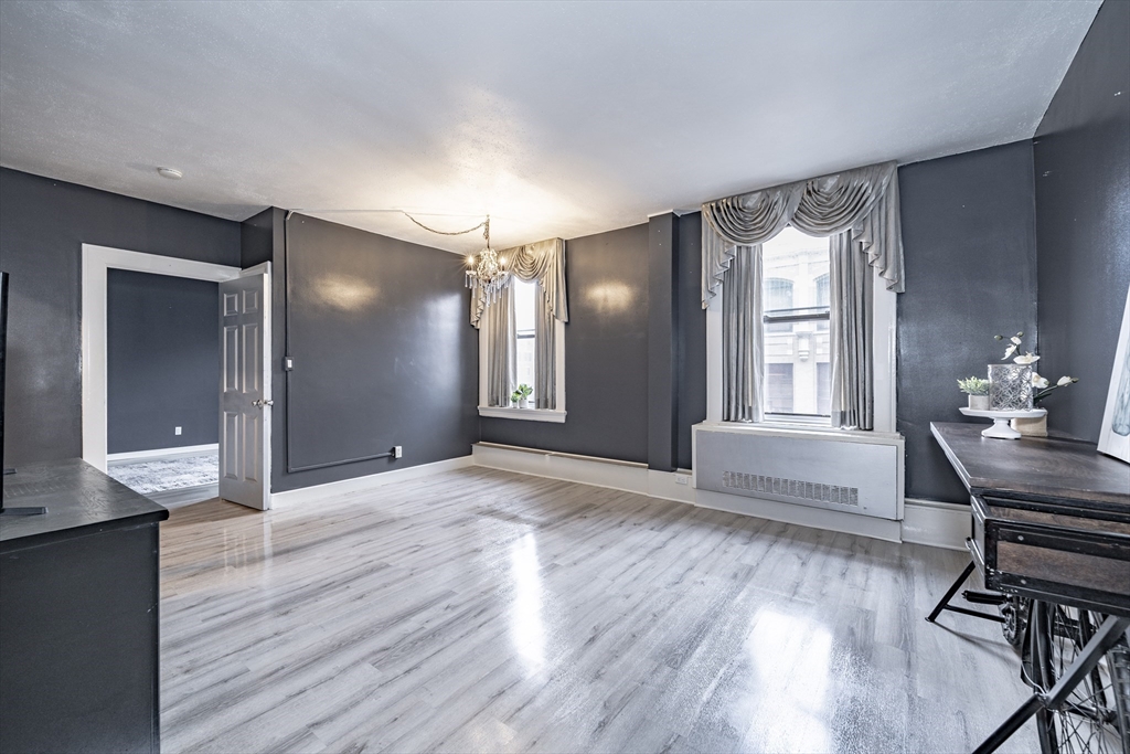 140 Chestnut Street, Unit 310 Springfield, MA 01103 - Photo 3 of 25 a view of a livingroom with furniture wooden floor and kitchen view