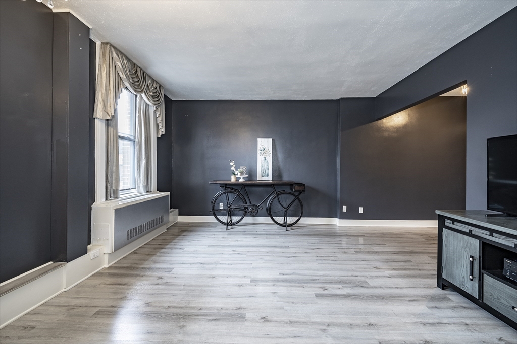 140 Chestnut Street, Unit 310 Springfield, MA 01103 - Photo 6 of 25 a view of a livingroom with a furniture and a flat screen tv