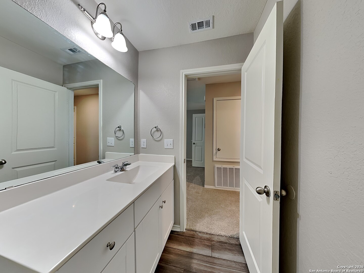 5206 Winding Street St. Hedwig, TX 78152 - Photo 12 of 17 a bathroom with a double vanity sink and a mirror