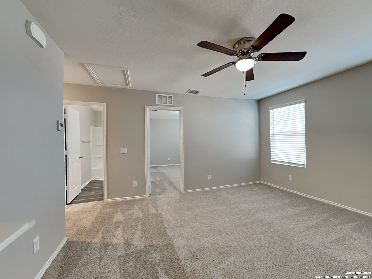 5206 Winding Street St. Hedwig, TX 78152 - Photo 13 of 17 a view of an empty room and a ceiling fan