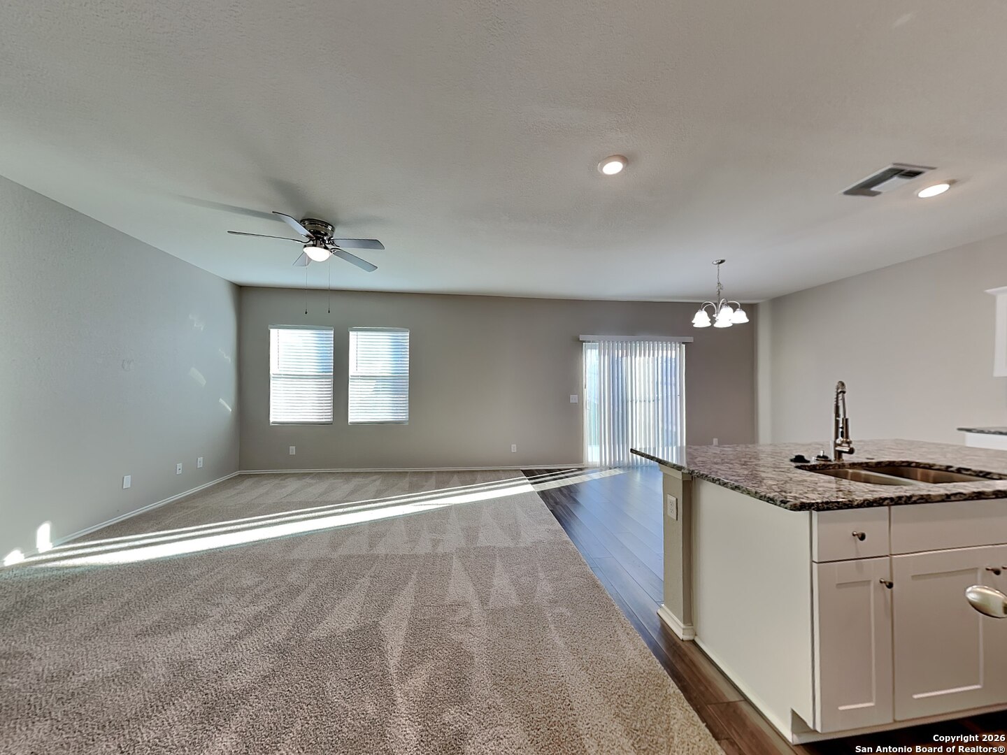 5206 Winding Street St. Hedwig, TX 78152 - Photo 2 of 17 a view of an empty room with window and wooden floor