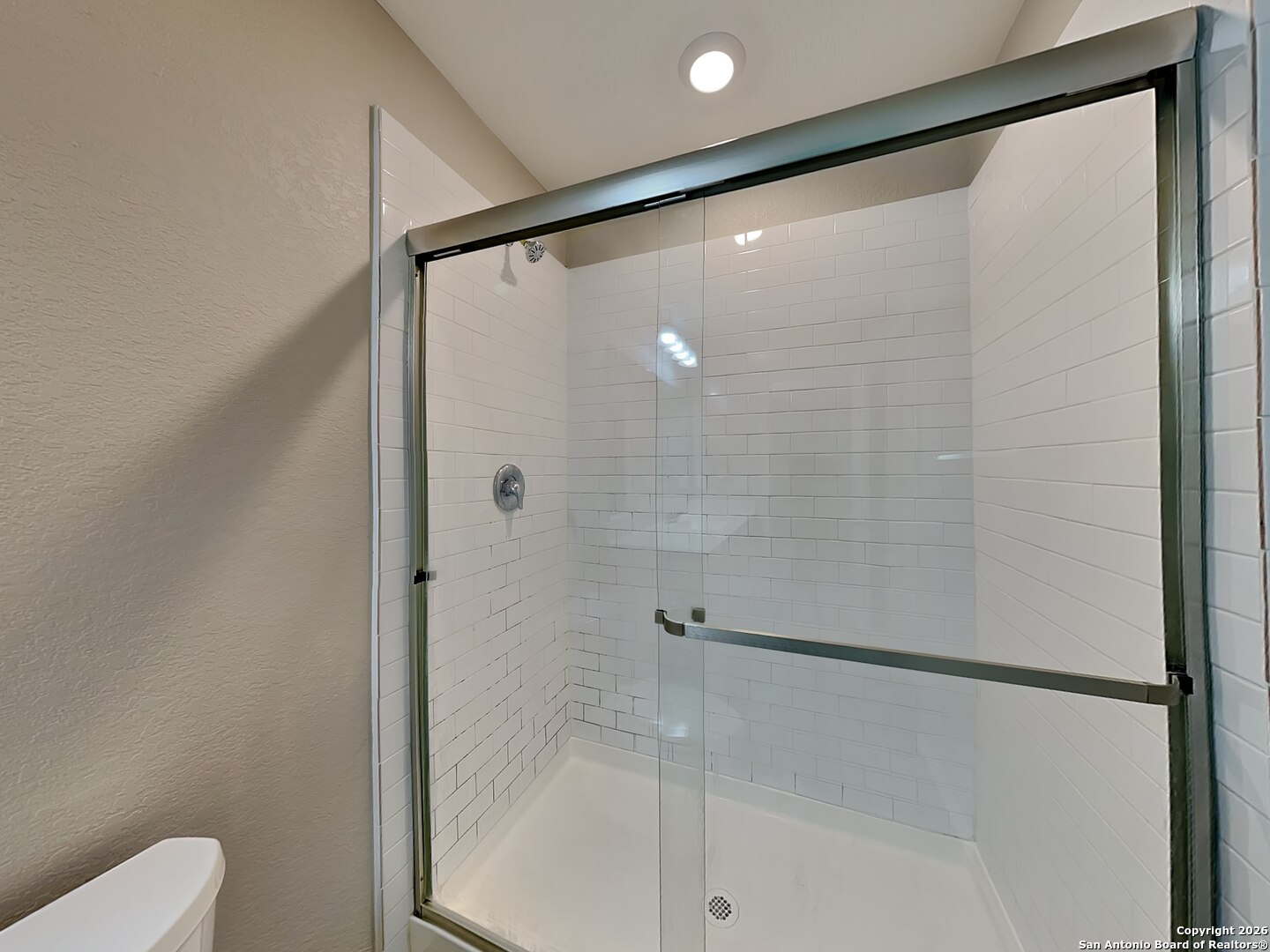 5206 Winding Street St. Hedwig, TX 78152 - Photo 7 of 17 a bathroom with a glass shower door