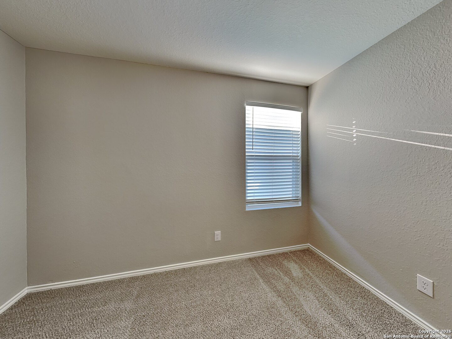 5206 Winding Street St. Hedwig, TX 78152 - Photo 10 of 17 a view of an empty room with a window