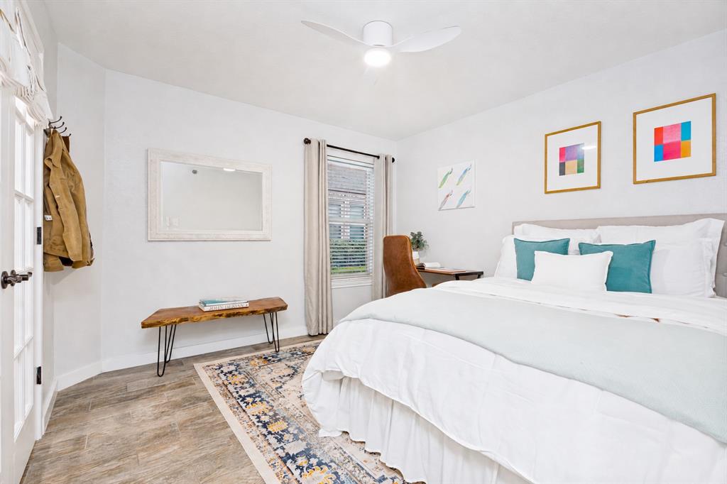 3642 Word Street Dallas, TX 75204 - Photo 17 of 29 a bedroom with a bed and a chandelier