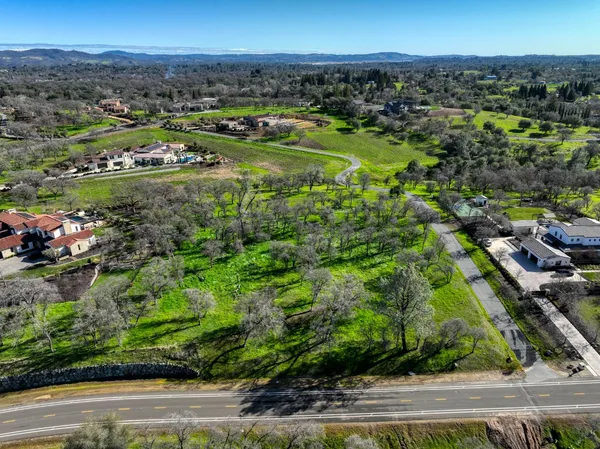 an aerial view of a houses with a yard
