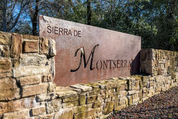 a sign board with buildings in the background