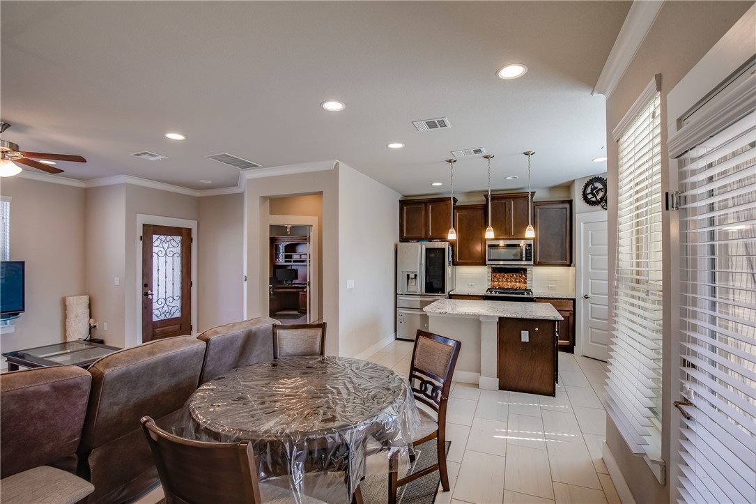 9707 McKnight Loop Austin, TX 78717 - Photo 5 of 17 a living room with stainless steel appliances furniture a rug and a kitchen view