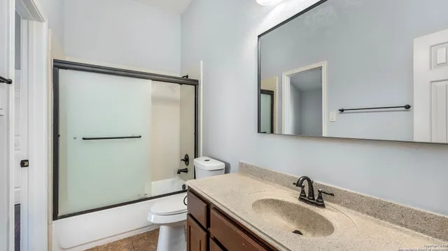 a bathroom with a sink toilet a mirror and vanity