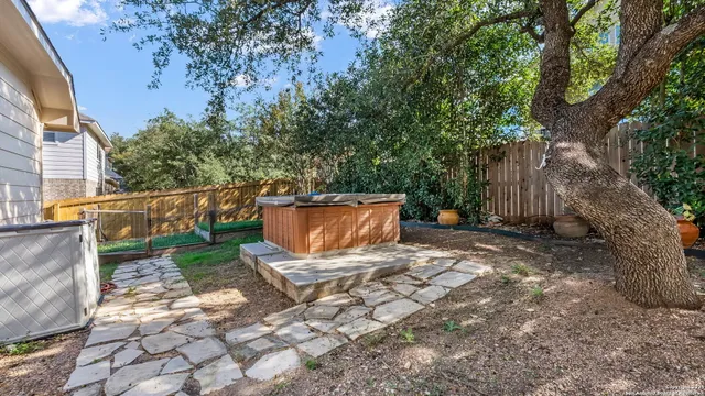 a view of backyard with outdoor seating and trees