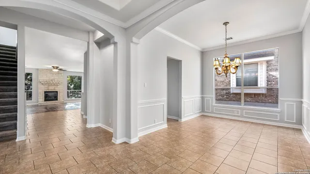 a view of a hallway view with wooden floor and chandelier
