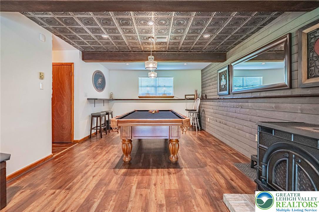 341 Lower Greenhill Road Kunkletown, PA 18058 - Photo 37 of 69 A vibrant game room showcases a classic billiards table, wood flooring, and a unique decorative ceiling.
