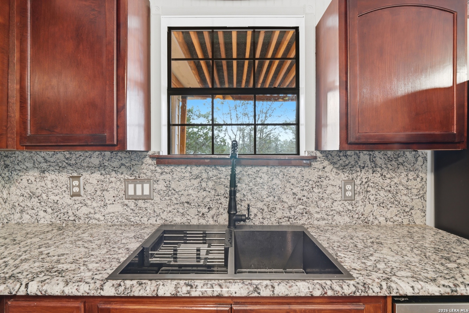 423 Las Hadas Spring Branch, TX 78070 - Photo 13 of 29 a kitchen with granite countertop a sink and a window