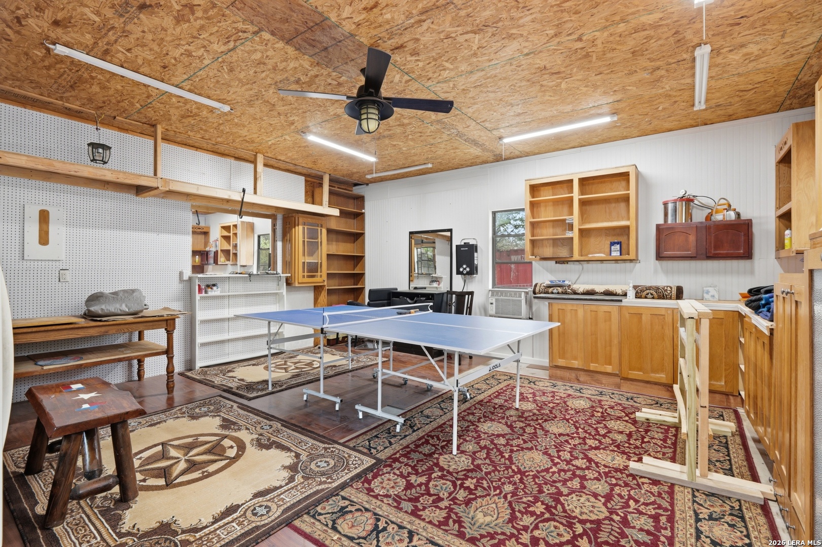 423 Las Hadas Spring Branch, TX 78070 - Photo 22 of 29 a work room with furniture a flat screen tv and a table