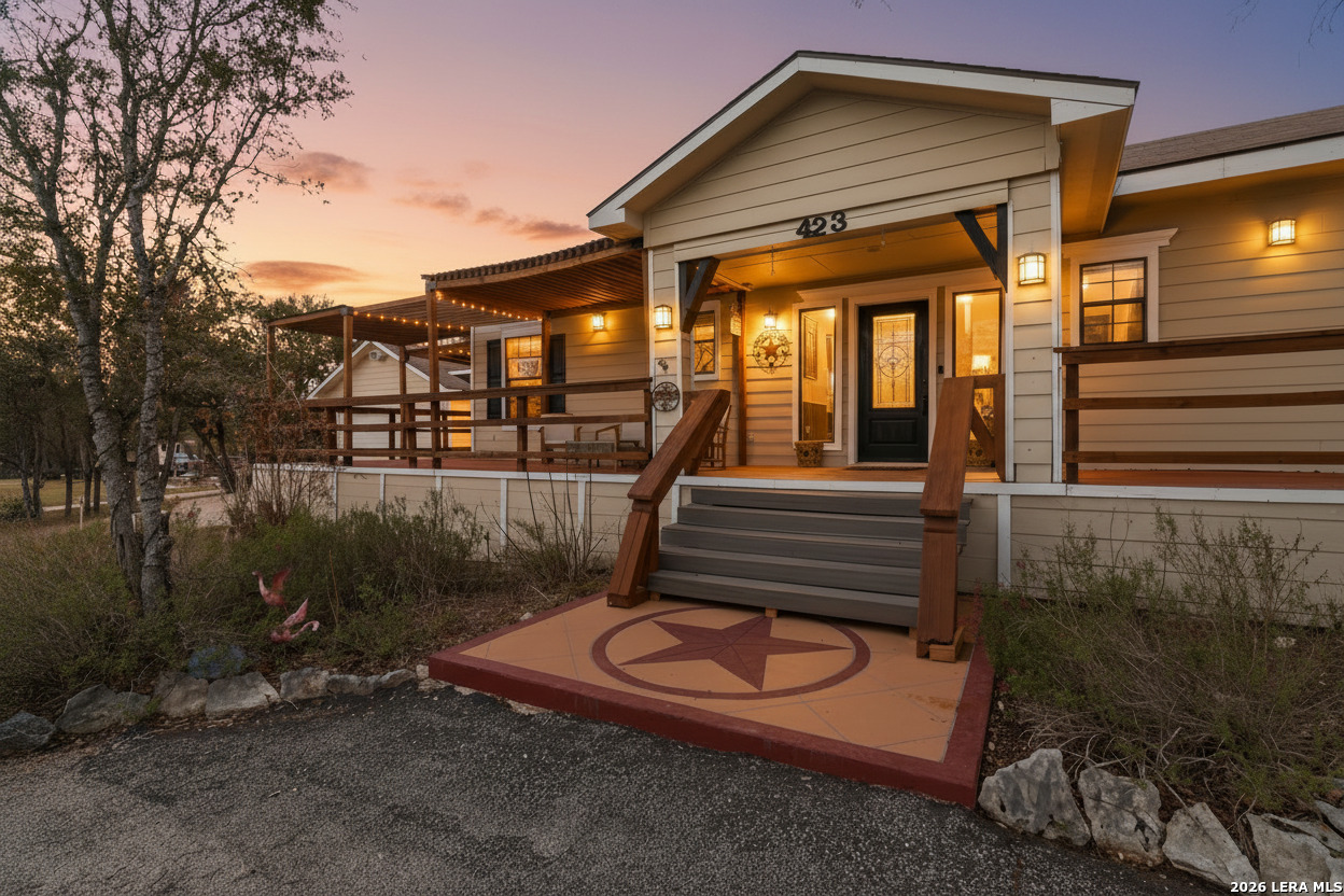 423 Las Hadas Spring Branch, TX 78070 - Photo 3 of 29 a backyard of a house with barbeque oven and outdoor seating
