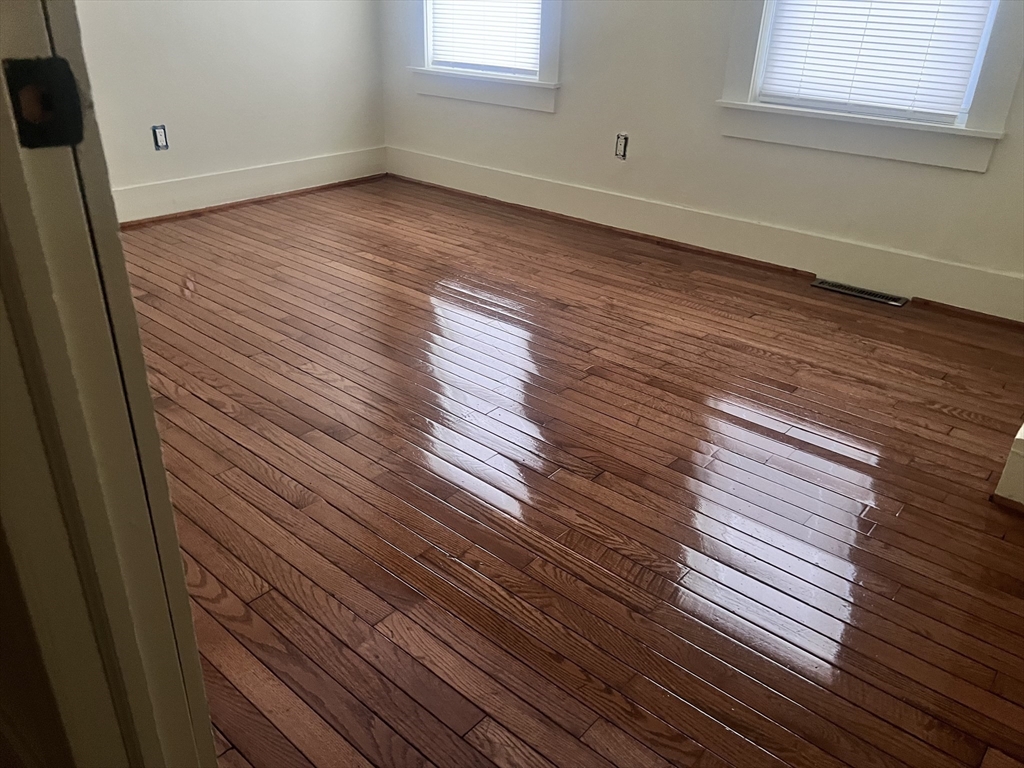 53 Thompson Street Springfield, MA 01109 - Photo 25 of 42 a view of an empty room with wooden floor and a window
