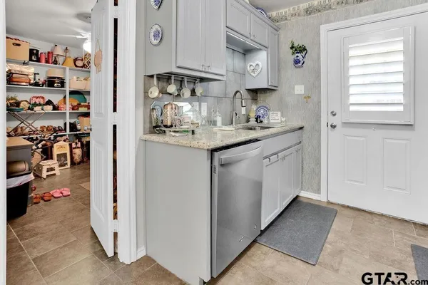 a kitchen with stainless steel appliances granite countertop a sink and cabinets
