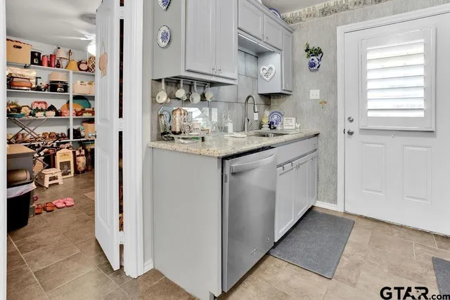 a kitchen with stainless steel appliances granite countertop a sink and cabinets