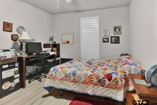 a bedroom with a bed and wooden floor