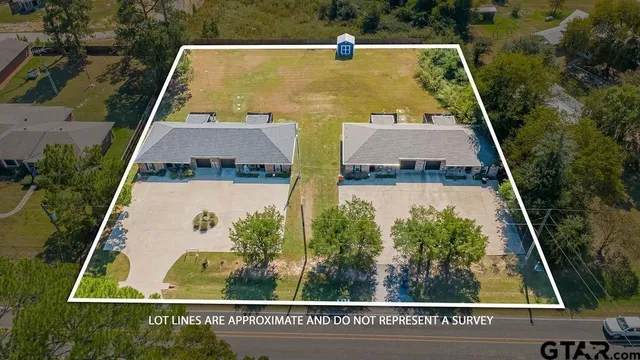 an aerial view of house with a yard