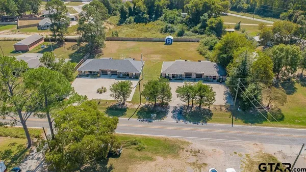 an aerial view of residential house with pool and yard