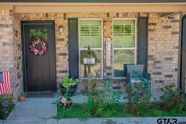 a front view of a building with a potted plant