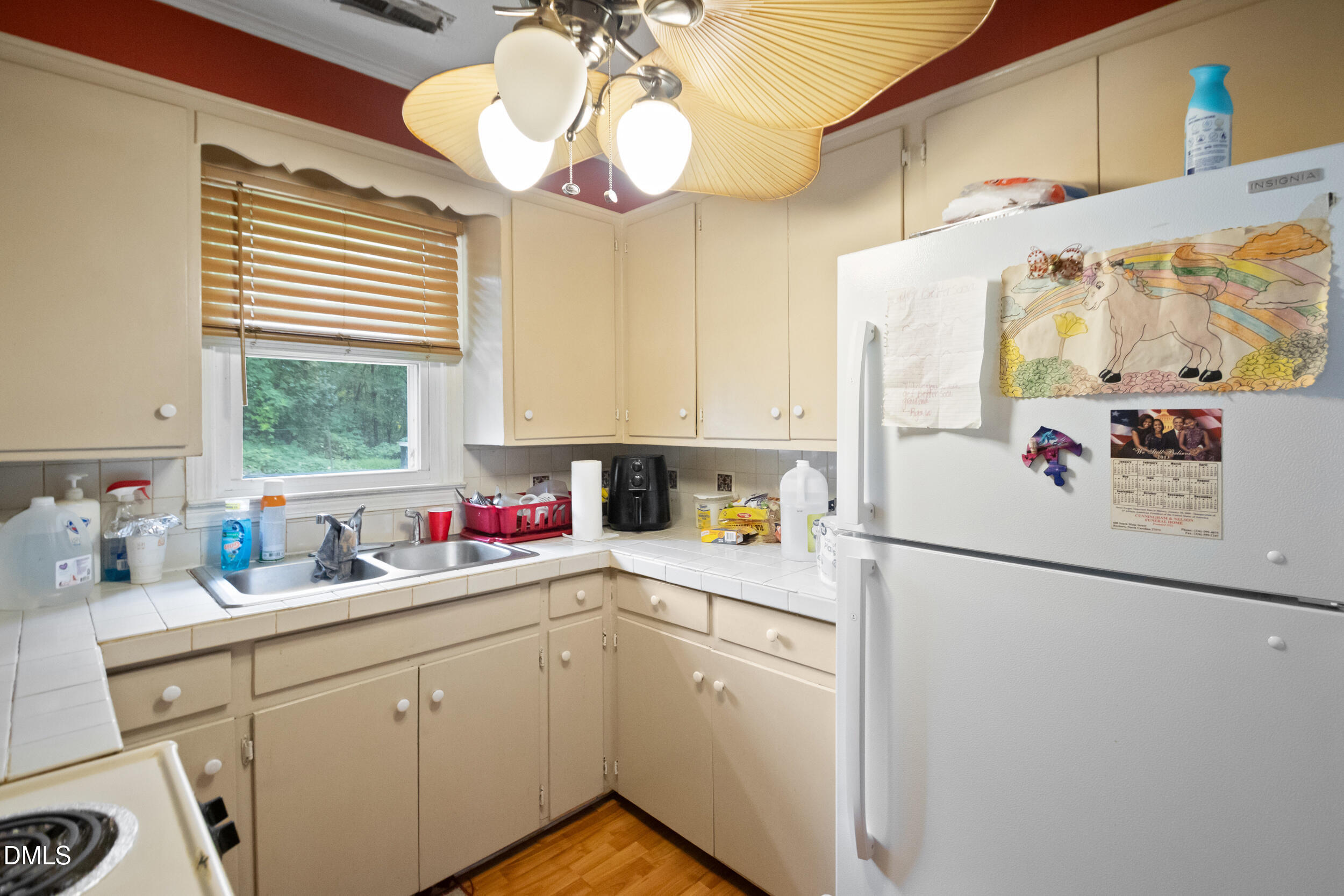 811 Jones Lester Road Roxboro, NC 27574 - Photo 12 of 27 a kitchen with a refrigerator a sink and cabinets